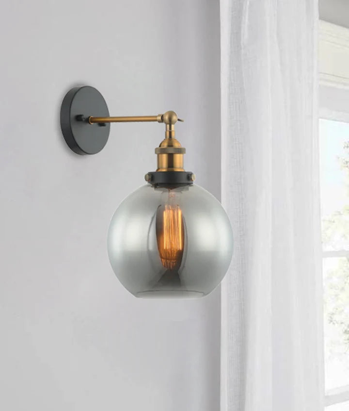 PESINI: Interior Swing Arm Smokey Black Glass with Antique Brass Highlight Wall Light