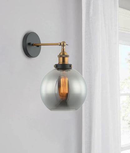 PESINI: Interior Swing Arm Smokey Black Glass with Antique Brass Highlight Wall Light